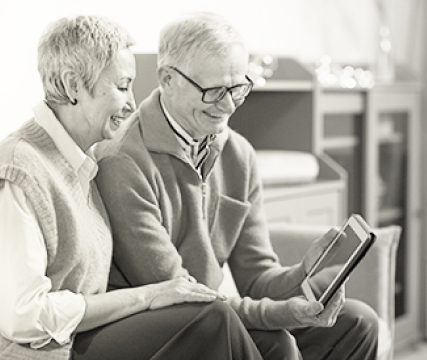  grandfather & grandmother looking at a tablet